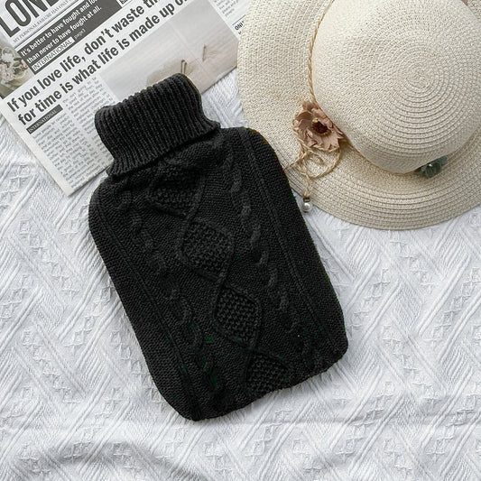 OliviaLiving Classic Knit Cover 2L black cable knit on a bedspread